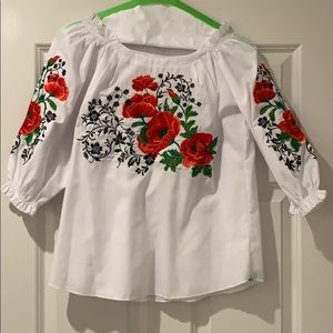 White, embroidered Mexican shirt with read roses.